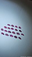 26 natural untreated marquise cut rubies displayed on white background, showing color and clarity
