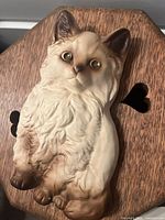 Front view of vintage cat chalkware figurine showing detailed cat face, fur texture, and coloration.