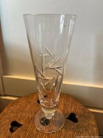 Full view of tall clear crystal bud vase with etched star pattern and pedestal base
