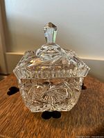 Front angle view of the crystal sugar dish showing intricate cut patterns and the faceted knob on the lid