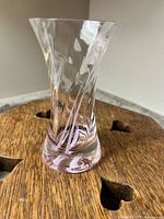 Front view of clear glass vase showing pink swirl embedded inside