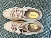 Top view of Michael Kors pink and gold casual shoes showing standard lace-up design, mixed material upper, and gold branded insoles.