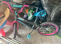 Side view of black and pink 16-inch kids bicycle, showing frame, tires, and handlebar with Jewel branding.
