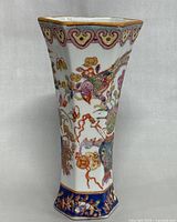 Front view of the vase showing phoenix and floral motifs, hexagonal shape and gold edging on top rim.
