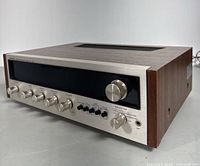 Angled view of Pioneer SX-525 stereo receiver showing wood veneer sides and front panel controls.