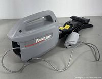 Power Jack electric car jack close-up showing gray handle and jack mechanism with attached power cord.