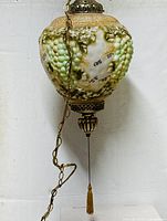 Full view of vintage grape-themed glass swag lamp hanging against white background.