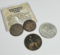 Four vintage collectible coins displayed with an informational card explaining the Shipwreck Treasure Coin recovered in 1809 from the coast of England. Coins show minor wear consistent with age.