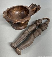 View of vintage hand carved wooden bowl and two carved wooden figurines on table, showing size and condition