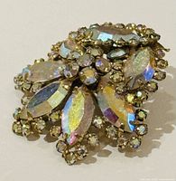 Front angle view of the vintage Sherman rhinestone brooch showing marquise and round iridescent rhinestones set in gold-tone metal.