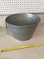 Side view of the 14-inch round galvanized metal wash tub showing its shape and handle.