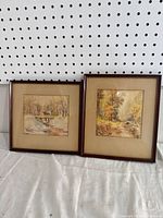 Two framed watercolour paintings by B. Bohart showing fall landscapes with bridges, matted and framed.