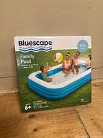 Box front of Bluescape family inflatable pool, showing family playing inside pool, dimensions and features