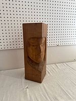Full view of the hand carved wooden block with indigenous face, showing size and shape.