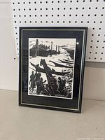 Framed black and white Indigenous canoe artwork, showing full front view of frame and artwork.