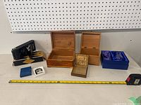 Wide shot of all items including Kodak camera, three jewelry boxes, and New Canary musical lighter in box