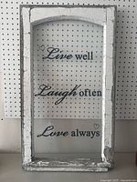 Full view of distressed white wooden framed glass window artwork with inspirational text