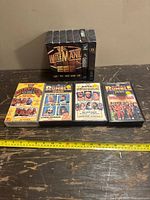 Photo showing full set of WWF VHS tapes including WrestleMania collection box and four separate VHS tapes with event title covers