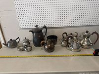 Full view of all tea set items lined up on table showing size and relative positions