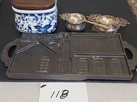 Salt box, cast iron mold and two tea strainers overview