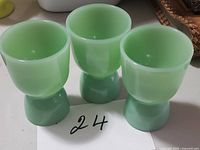Three jadeite glass egg cups front view
