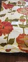 Full view of folded floral fabric showing pattern scale and colors