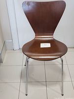 Front full view of one chair showing design and legs