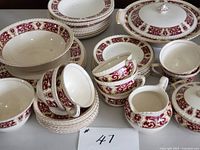 Group view of Johnson Bros china set showing cups, saucers, platter, covered casserole, serving bowl, gravy boat