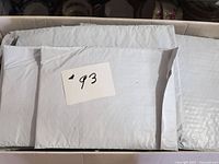 Stack of grey poly bubble mailers in box