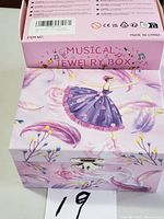 Closed jewelry box with original outer sleeve showing graphics and text