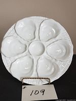Front view of white porcelain oyster plate