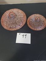 Top view of both lids showing pattern and finial knobs