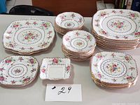 stacks of square dinner plates, cake plates, bowls, small dish