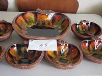 Full set showing large bowl and six small bowls