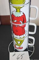 Mugs stacked showing Grinch body illustration front view in stand