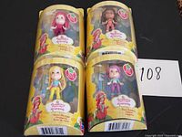 All four sealed Strawberry Shortcake mini dolls in original packaging