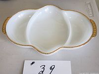 Top view of milk glass tray showing three compartments and gold beaded rim