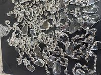 Overview of assorted crystal prisms and strands on dark background