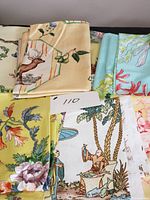 Assorted folded fabric samples showing various prints and colors