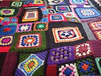 Full view showing multiple granny squares and color variety