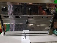 Front view showing four labeled drawers and bread compartment