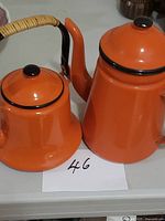Coffee pot and kettle side by side showing size and color
