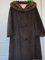 Full view of front of coat showing texture, buttons, overall length