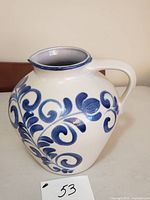 Front view of cream and blue stoneware jug