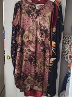 Four caftans hanging, front paisley print