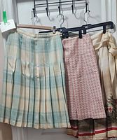 Three skirts on hangers showing overall styles