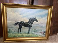 Frontal photo of the entire framed horse painting showing the black horse and background with minor frame wear visible.