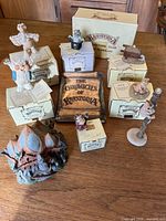 Overview photo showing 8 figurines with original boxes and the large base/display with 'The Chronicles of Krystonia' sign