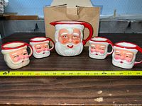 Full set arranged in front of a tape measure showing size, with a cardboard box background.