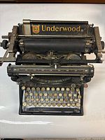 Full top view of the black Underwood typewriter showing keyboard and carriage with logo.